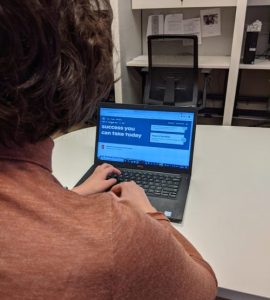 Back of person's head while using a lap in an office